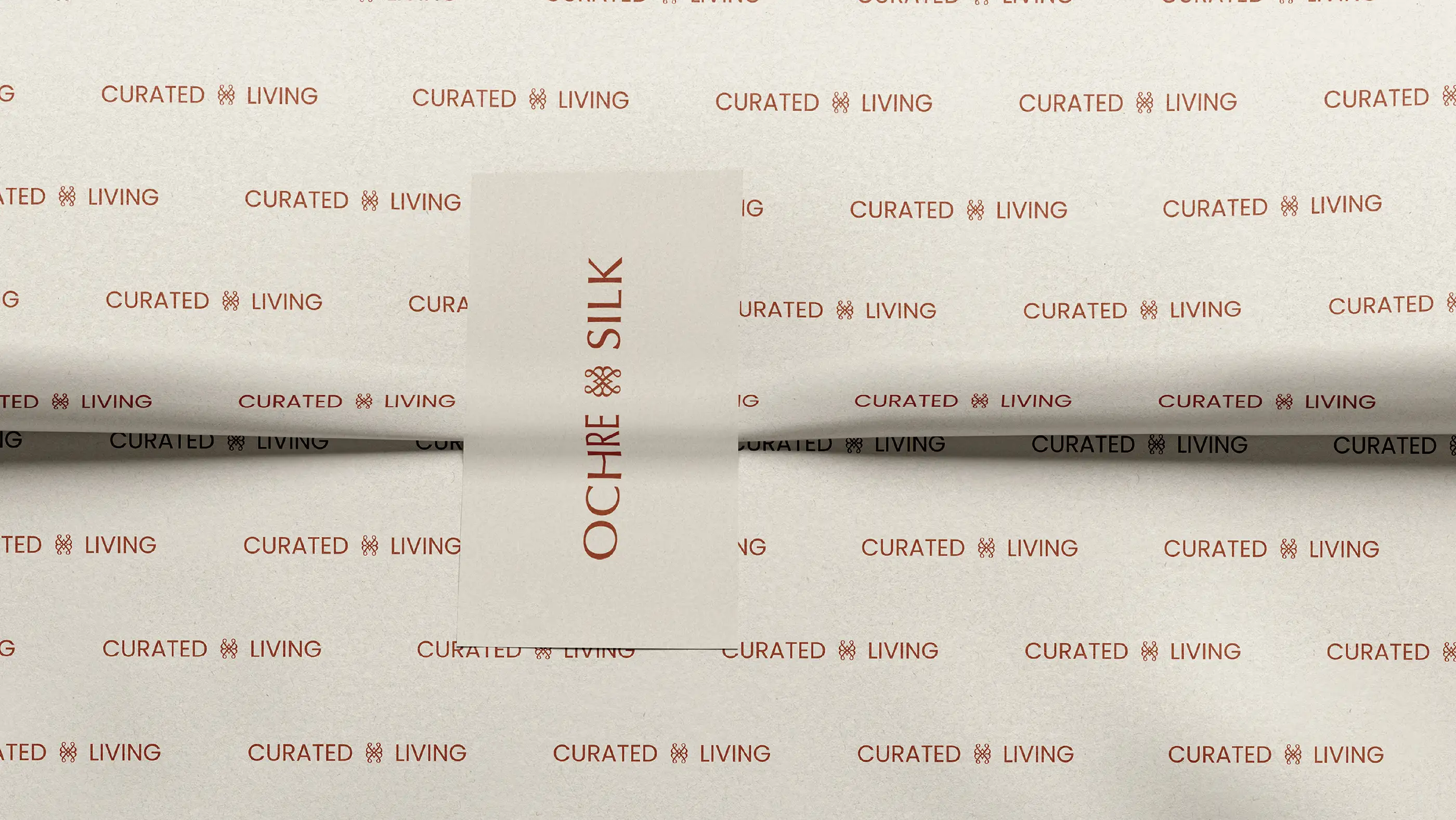 Ochre and Silk tissue paper printed with a repeating 'Curated living' pattern