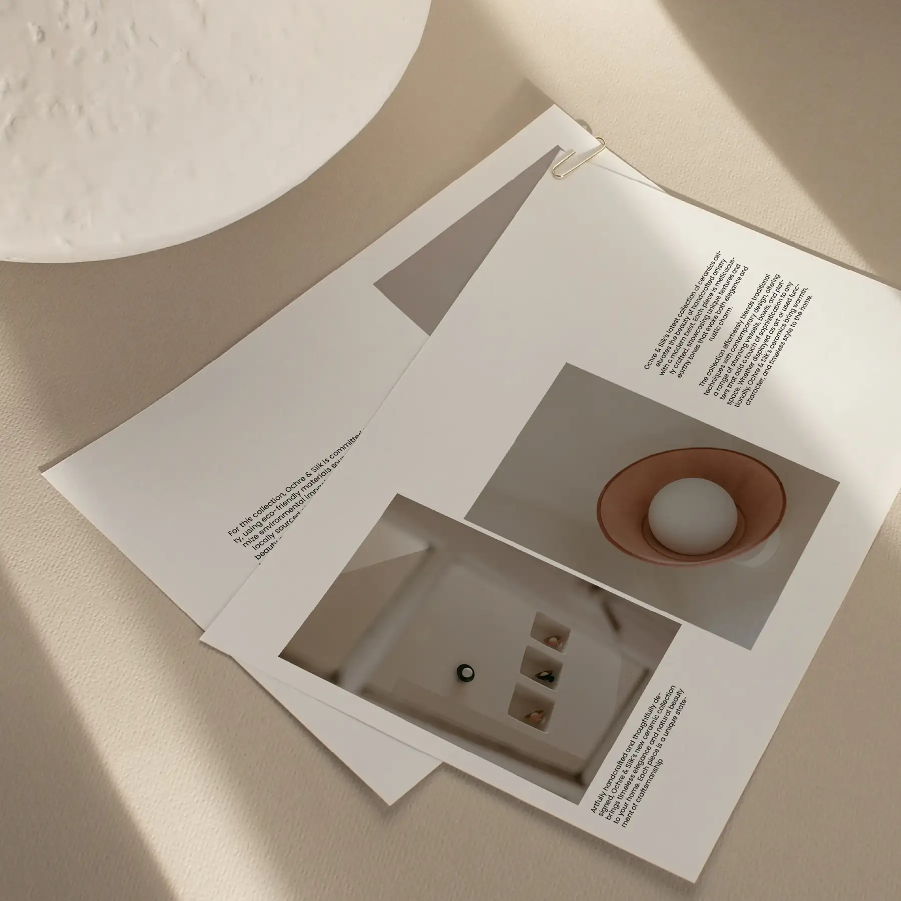 Ochre and Silk product booklet open on a pale surface, showing photography and specification copy