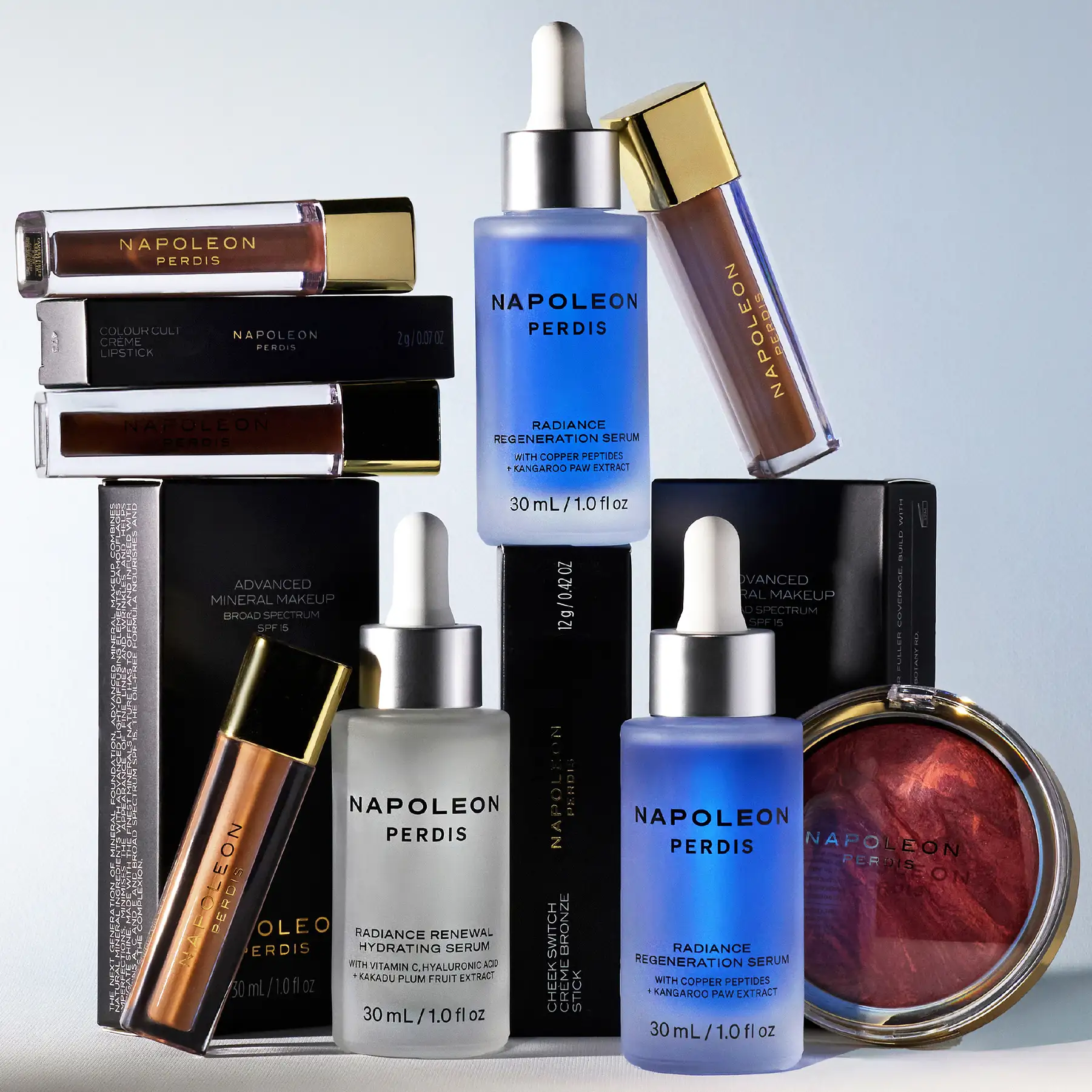 Full Napoleon Perdis product range grouped together — serums, primer, lip glosses, mascara and blush