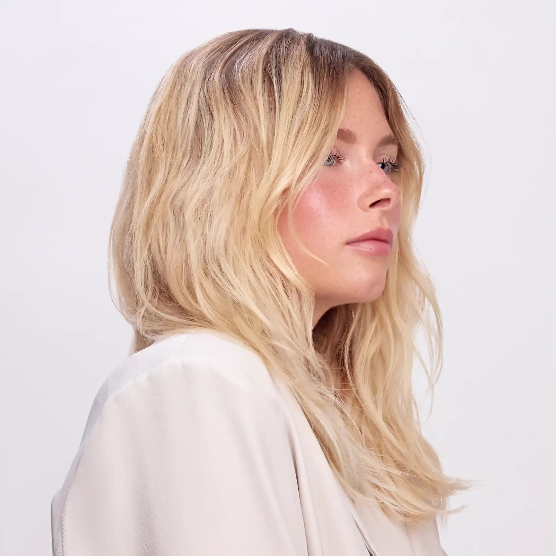 CPR Hair campaign portrait — blonde model in a cream shirt, photographed in profile