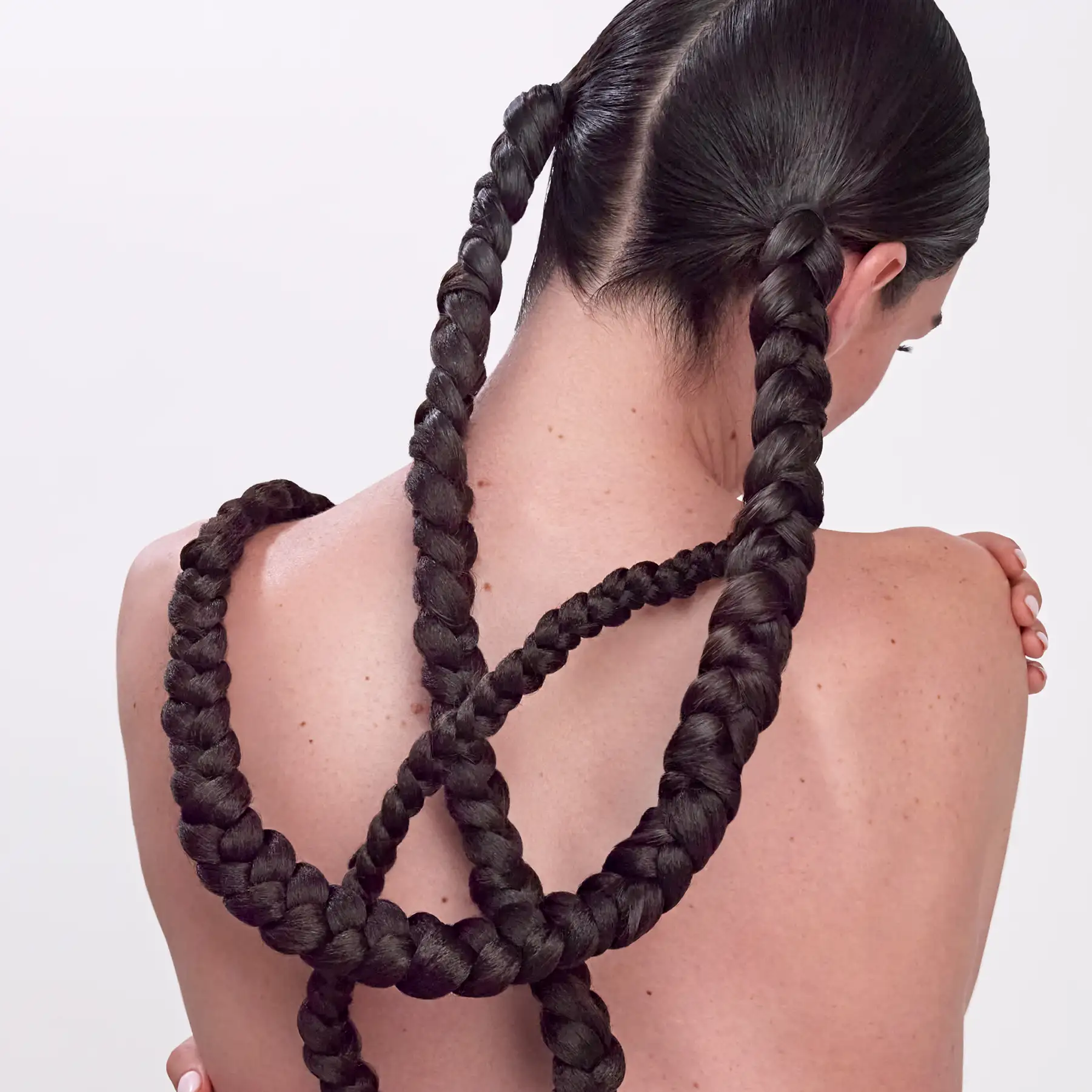 CPR Hair editorial photography — model photographed from behind with long looped braids across her back