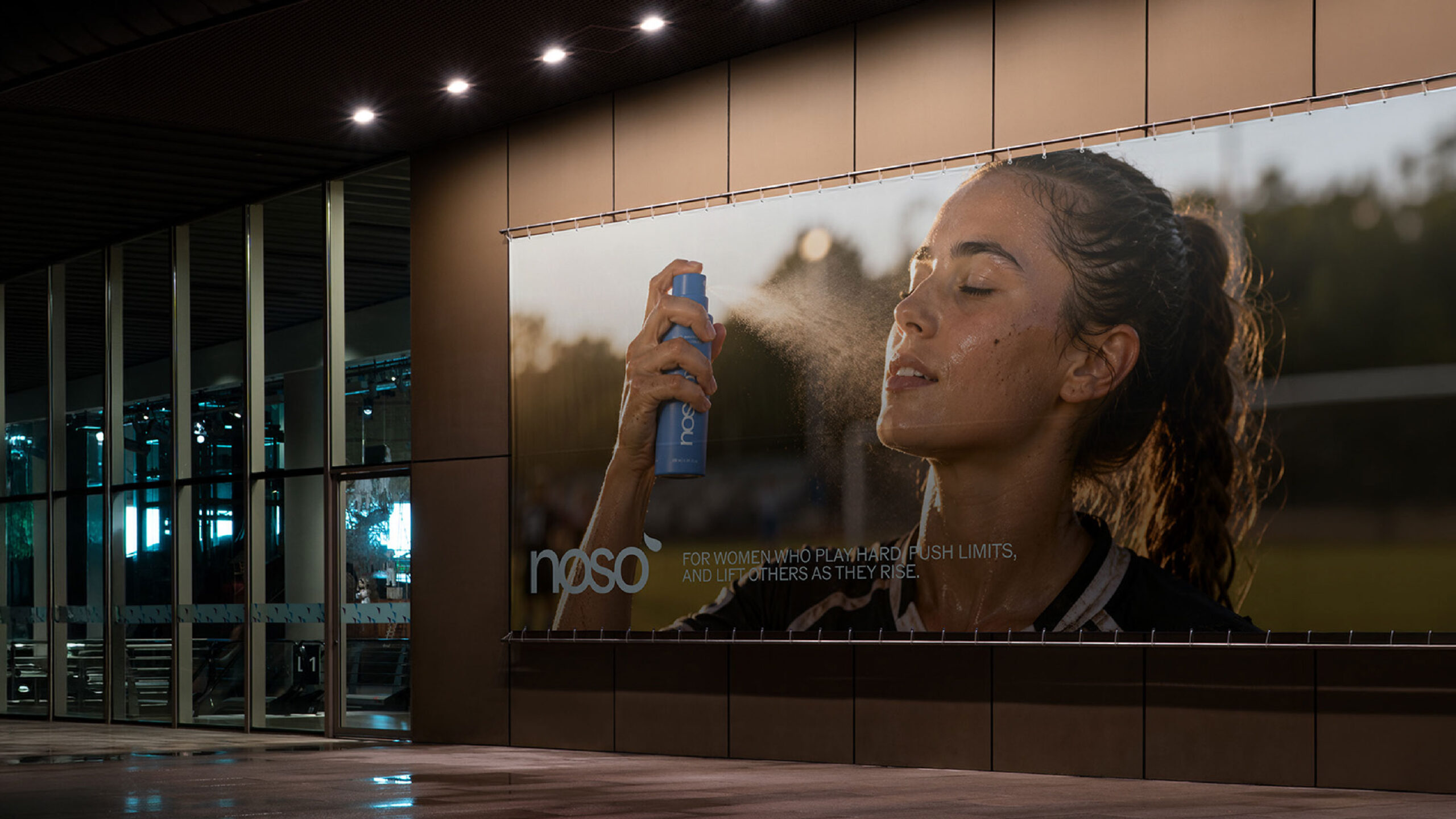Noso campaign billboard on a building facade at night