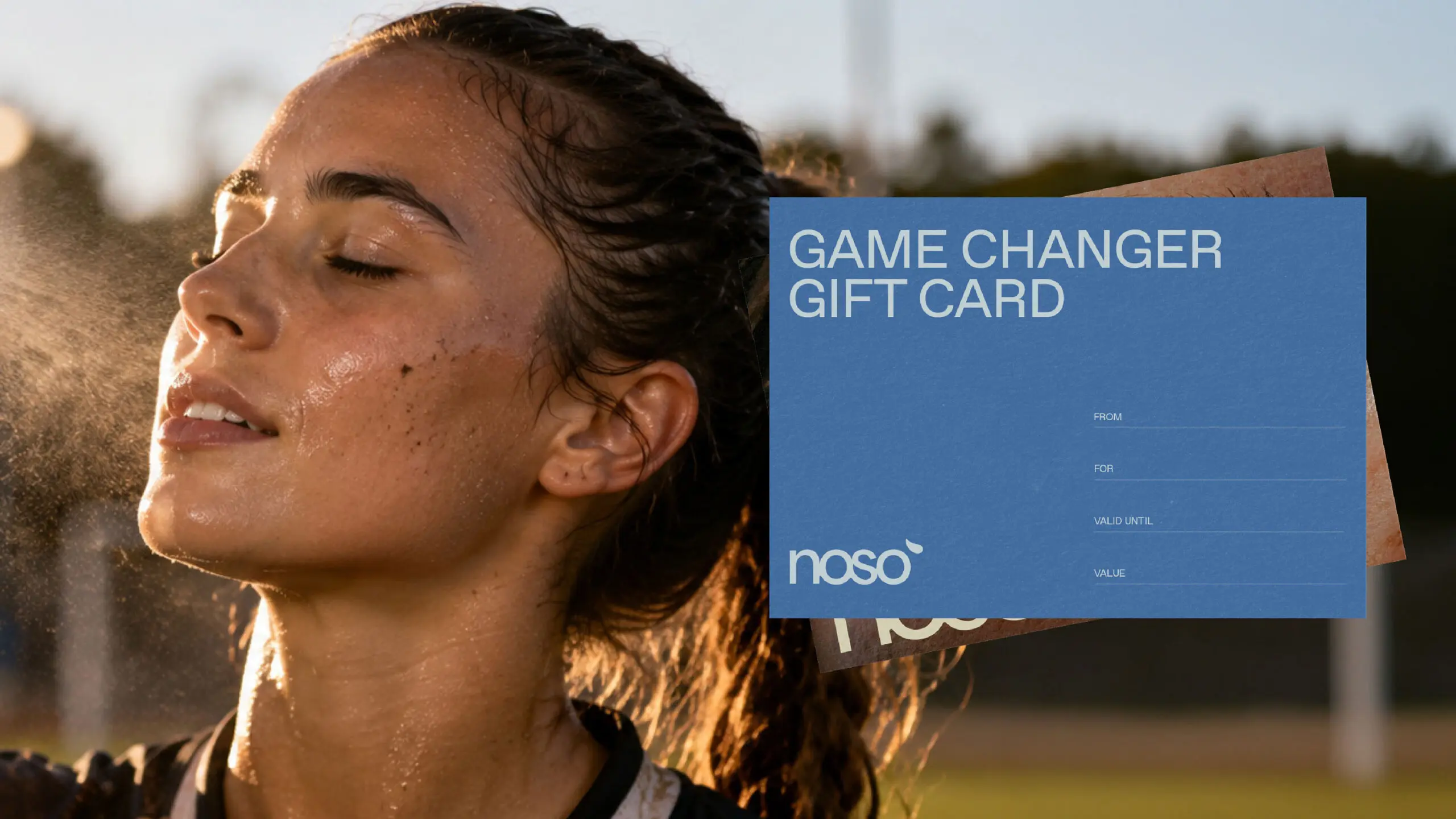 Noso gift card design held beside an athlete using the spray